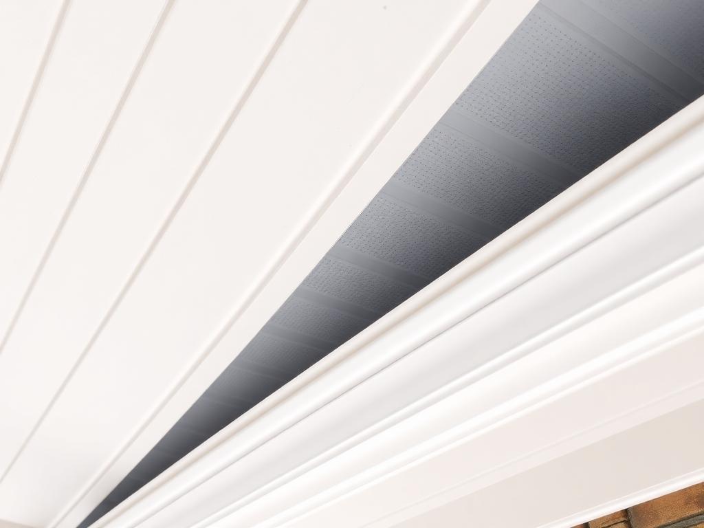 Soffit intake vents under the eave paired with a continuous ridge vent on a properly ventilated NJ shingle roof